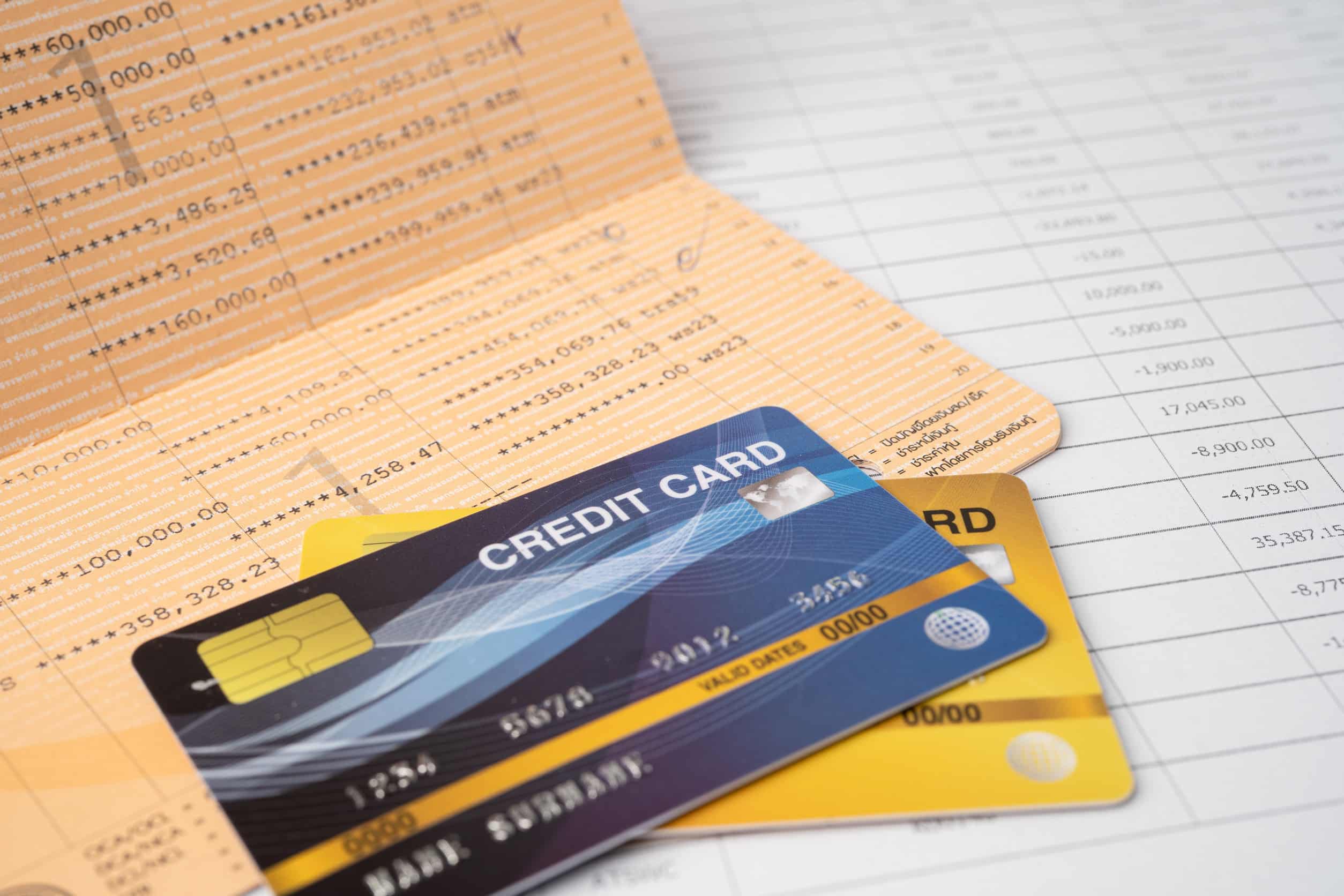Pen on account book bank with credit cards
