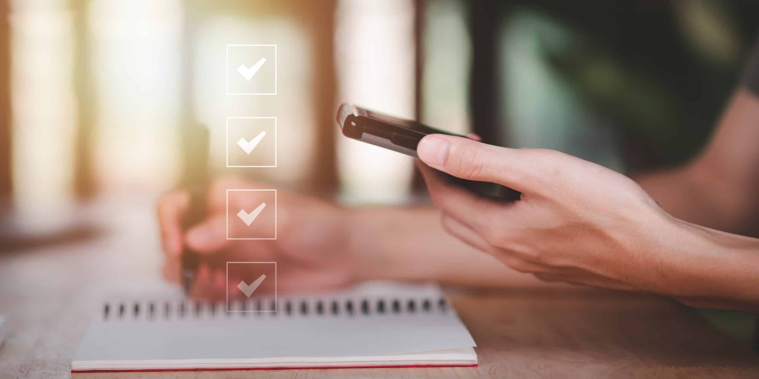 Checklist overlayed over image of person holding phone and writing in notebook