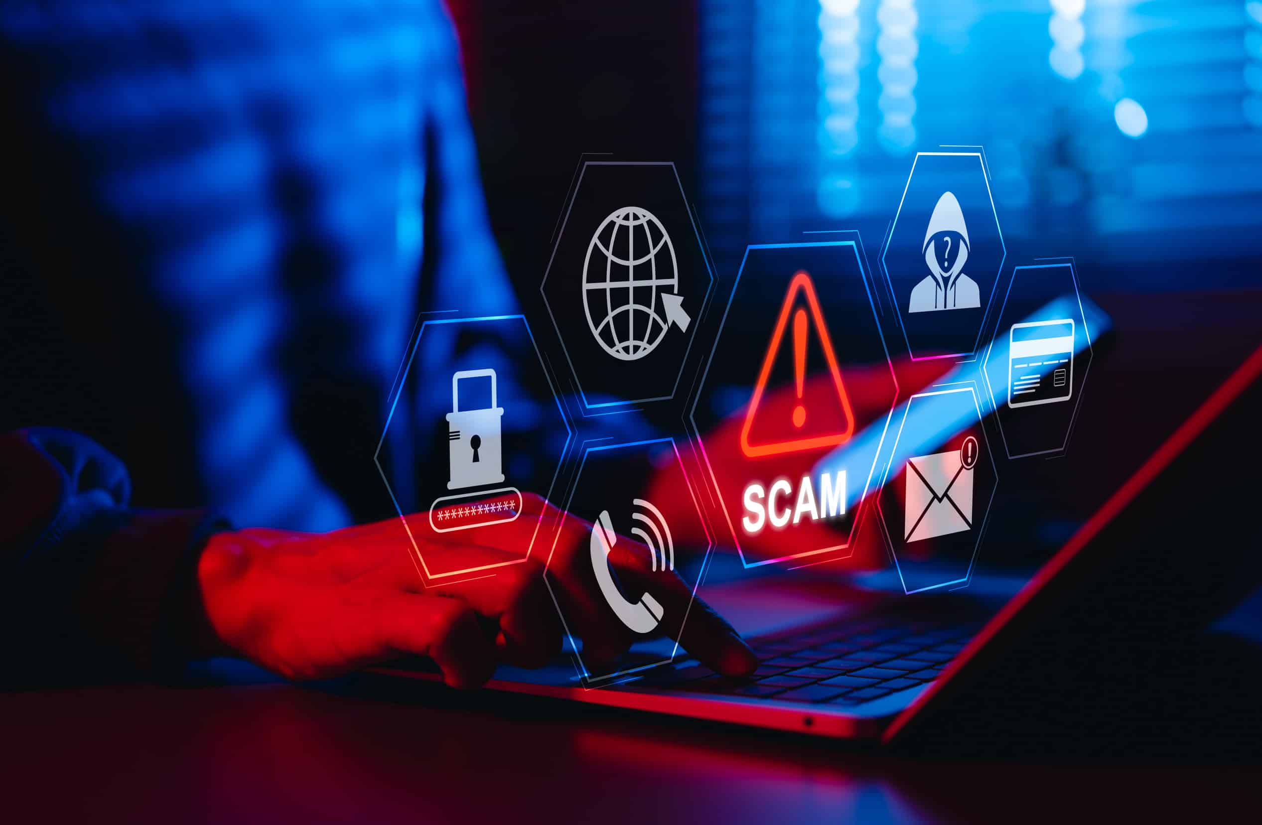 Person typing on a computer being scammed.