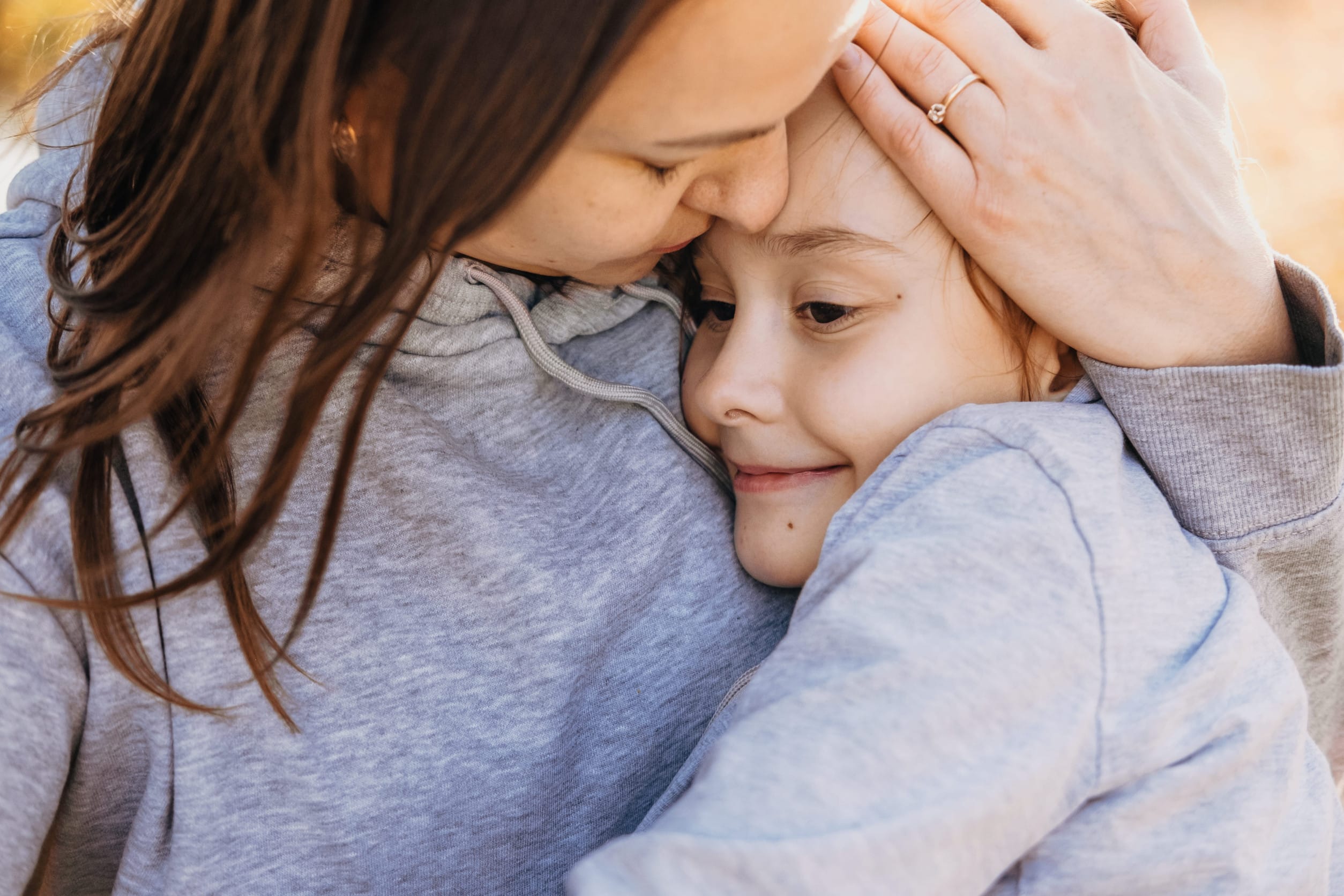 Close up of son hugging his mom