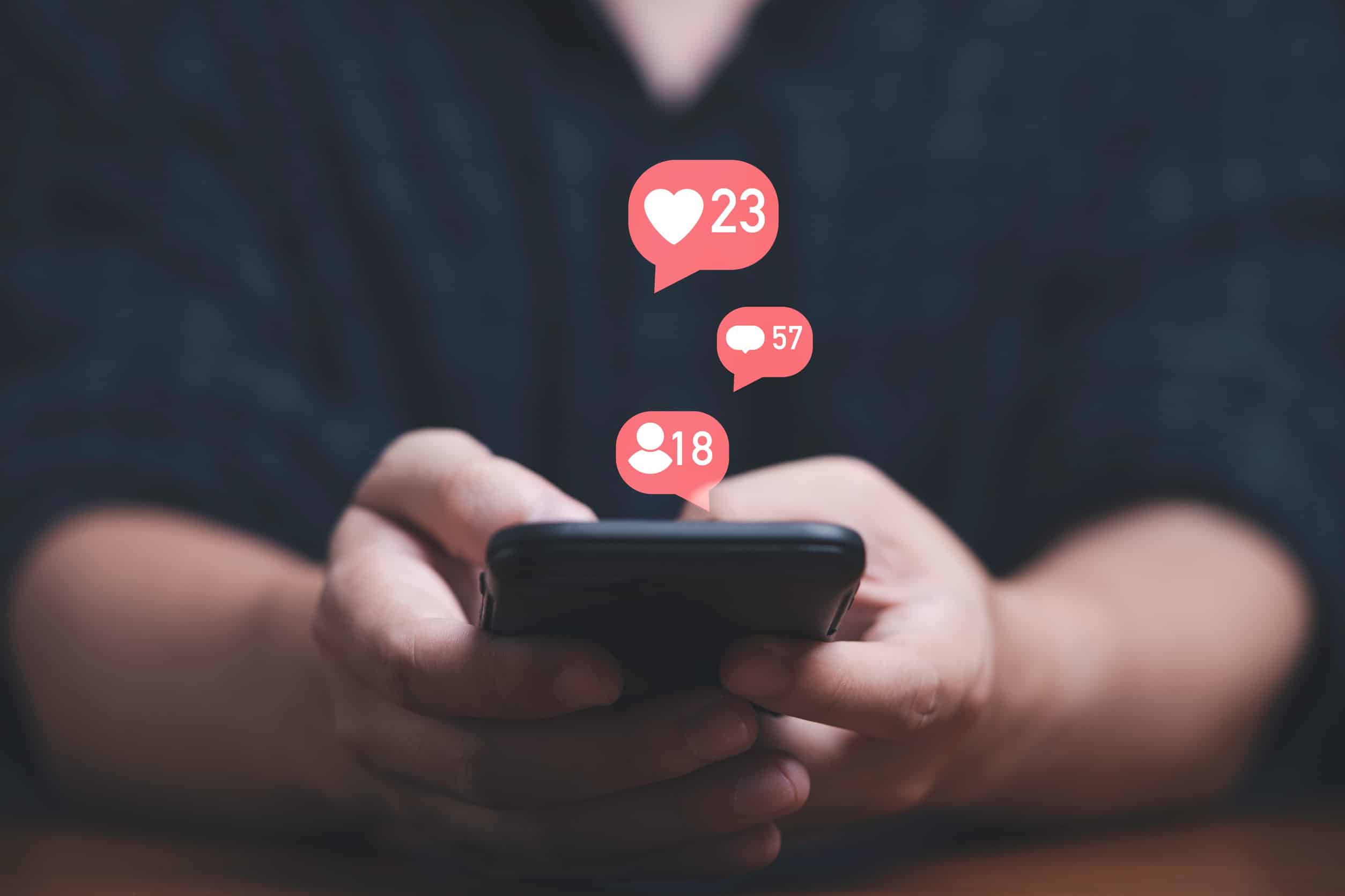 Man using smartphone with social media icons