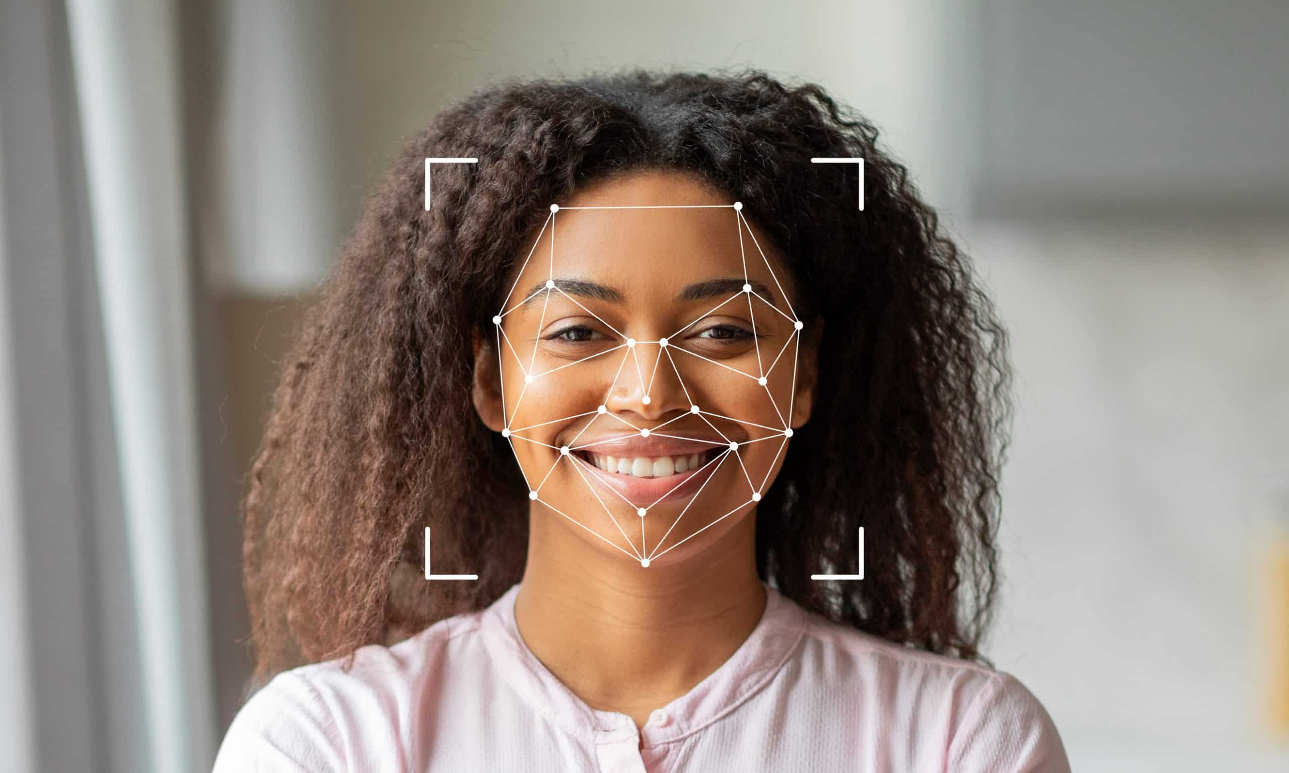 Facial recognition technology with woman smiling indoors
